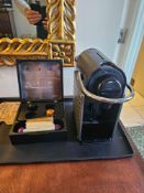 Nespresso Pod machine A compact capsule-based espresso machine in matte black with ribbed
