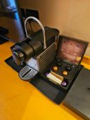 Nespresso Pod machine A compact capsule-based espresso machine in matte black with ribbed