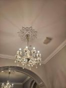 Ten-arm chandelier with polished brass frame and cut glass dressing. Each curved arm supports a