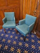 A set of four Danubio teal upholstered contract armchairs with curved backrests and solid wood