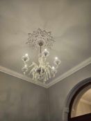 Six-arm chandelier with polished brass frame and cut glass dressing. Each curved arm supports a