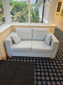 Contemporary two-seater sofa, approx. 170 cm wide × 90 cm deep × 70 cm high. Upholstered in light