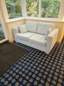 Contemporary two-seater sofa, approx. 170 cm wide × 90 cm deep × 70 cm high. Upholstered in light