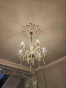 Six-arm chandelier with polished brass frame and cut glass dressing. Each curved arm supports a