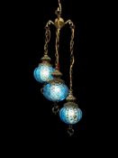 VINTAGE MID-CENTURY BRASS AND BLUE GLASS THREE LIGHT HANGING SWAG LAMP
