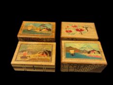 FOUR VINTAGE JAPANESE PUZZLE BOXES WITH INTRICATE INLAY EACH WITH SCENERY