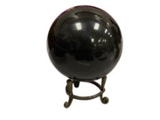 POLISHED BLACK ONYX SPHERE WITH BRONZE THREE FOOTED STAND