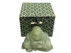 POLISHED GREEN JADE CARVING OF A LAUGHING SEATED BUDDHA