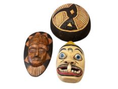 TWO AFRICAN HAND CARVED WOODEN MASKS AND CARVED GOURDS