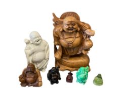 SEATED AND STANDING BUDDHA FIGURES MADE FROM VARIOUS MEDIUMS SUCH AS CERAMIC, WOOD, AND RESIN