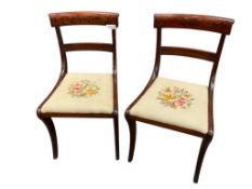 PAIR OF ANTIQUE MAHOGANY SABER LEG NEEDLEPOINT SIDE CHAIR WITH ELEGANT CURLED TOP AND FOLIATE DES...