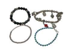 FOUR FASHION BEAD BRACELETS INCLUDING RELIGIOUS CHARM DANGLE BRACELET