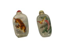 TWO VINTAGE REVERSE PAINTED CHINESE GLASS SNUFF BOTTLES WITH STONE AND GLASS TOPS
