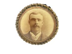 ANTIQUE GOLD FILLED MOURNING BROOCH FEATURING SEPIA TONED PHOTOGRAPH OF MIDDLE AGED MALE
