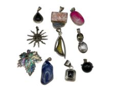 10 ASSORTED STERLING SILVER PENDANTS INCLUDING INLAID SHELL, SIGNED PIECES, SUN FACE, AND MORE