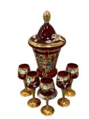 RUBY RED BOHEMIA ART GLASS LIDDED CANDY JAR AND MATCHING CORDIALS WITH ENAMELED AND GILT DESIGN