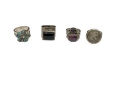 FOUR STERLING SILVER SEMI-PRECIOUS STONE RINGS INCLUDING ONYX, ABALONE SHELL, GARNET, AND MORE