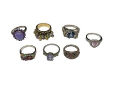 SEVEN STERLING SILVER FASHION RINGS FEATURING VARIOUS DESIGNS