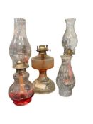 THREE CLEAR GLASS OIL LAMPS ALL WITH CLEAR GLASS CHIMMNEY
