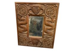 19TH CENTURY CHINESE SCULPTED WOOD MIRROR WITH VARIOUS ELEENTS SUCH AS MEDALLIONS, DRAGONS, AND B...