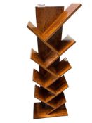 UNIQUE ALTERNATING ANGLE BOOK SHELF FEATURING SEVERAL TIERS OF CROSS HATCHED SHELVES