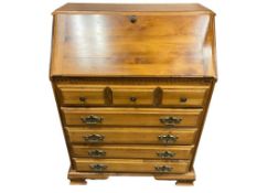 MID-CENTURY MAPLE WOOD DROP-FRONT SECRETARY DESK WITH BRASS PULLS AND THREE DRAWERS