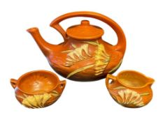 EARLY TO MID 20TH CENTURY ROSEVILLE POTTERY FREESIA TANGERINE TEAPOT, CREAMER, AND SUGAR BOWL
