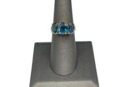 10K YELLOW GOLD OVAL CUT LAB BLUE TOPAZ FASHION RING FEATURING THREE OVAL CUT LAB BLUE TOPAZ
