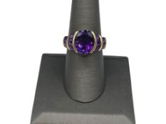 10K YELLOW GOLD AMETHYST FASHION RING FEATURING OVAL CUT AMETHYST IN CENTER