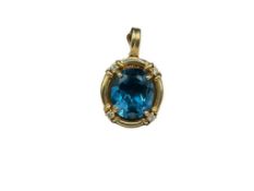 14K YELLOW GOLD OVAL CUT LONDON BLUE TOPAZ AND DIAMOND FASHION PENDANT