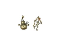 TWO 10K YELLOW GOLD FIGURAL PENDANTS INCLUDING SNOWMAN AND BLACK HILLS GOLD FROG
