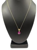 10K YELLOW GOLD SYNTHETIC PINK SAPPHIRE FACETED TEAR DROP PENDANT WITH DIAMOND RIBBON BAIL