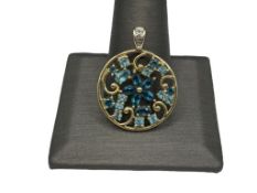 14K YELLOW GOLD BLUE SPINEL AND IOLITE FLOWER PENDANT FEATURING PIERCED DESIGN