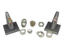 NINE STERLING SILVER RINGS FEATURING VARIOUS DESIGNS