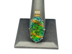 STUNNING OVAL AUSTRALIAN BLACK OPAL DOUBLET SET IN PLATINUM AND PRONG MOUNTED IN 14K YELLOW GOLD