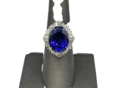 LADIES' PLATINUM OVAL CUT TANZANITE AND DIAMOND RING FEATURING A 9.79CT OVAL CUT TANZANITE