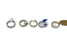 FIVE NEW MEN'S STAINLESS STEEL WEDDING BANDS INCLUDING PHEBUS AND THREE WITH SPINNER BAND DESIGN