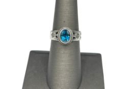 STERLING SILVER BLUE TOPAZ RING FEATURING UNIQUE DESIGN ON SHOULDERS OF SHANK