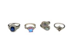 FOUR STERLING SILVER FASHION RINGS FEATURING SYNTHETIC GEMSTONES