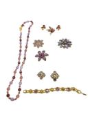 ASSORTED PURPLE RHINESTONE AND BEAD JEWELRY INCLUDING NECKLACE, BRACELET, BROOCHES, AND MORE