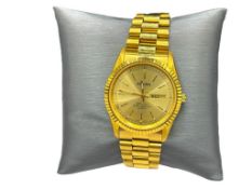 GRUEN GOLD TONE STAINLESS STEEL WRISTWATCH FEATURING DATE AND DAY ADJUST