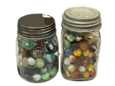 TWO VINTAGE EMBOSSED GLAS MASON JARS FILLED WITH VINTAGE MARBLES CAT-EYE, BOULDERS, CLEARIES