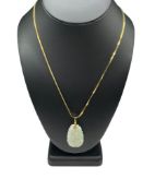 CARVED JADE PENDANT FEATURING GREEN AND WHITE TONES ON GOLD TONE NAPIER NECKLACE