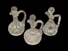 THREE ANTIQUE AMERICAN BRILLIANT PERIOD CUT GLASS CRUETS INCLUDING A TRIPLE SPOUT CRUET