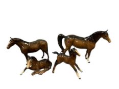 FOUR BESWICK ENGLISH POTTERY HAND PAINTED PORCELAIN GLOSSY BROWN FOAL AND COLT HORSE FIGURES