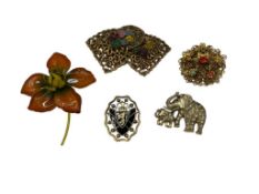 FIVE COSTUME JEWELRY BROOCHES INCLUDING ENAMLED PIECES, FLOWER DESIGNS, AND ELEPHANTS