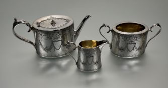 An Edwardian epns engraved oval three peice tea set in the Adam style: t pot h. x 12cm l. x 28cm