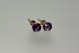 A pair of 9ct gold set amethyst faceted stud earrings each stone approximately 2ct with screw