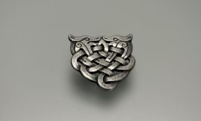 A Scottish Arran silver entwined mythical beast brooch: h. x 3cm stamped verso EM 16.1g