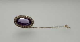 An Edwardian yellow metal brooch or oval form set oval facet cut amethyst approximately 4.5ct within
